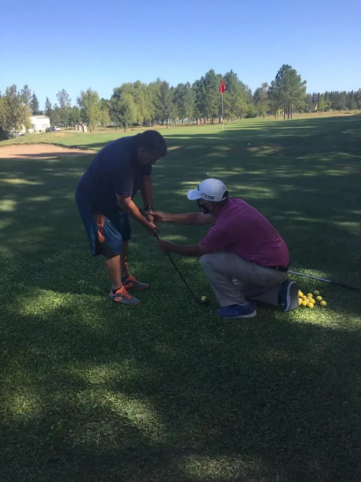 profesor y alumno de golf manos acomodadas